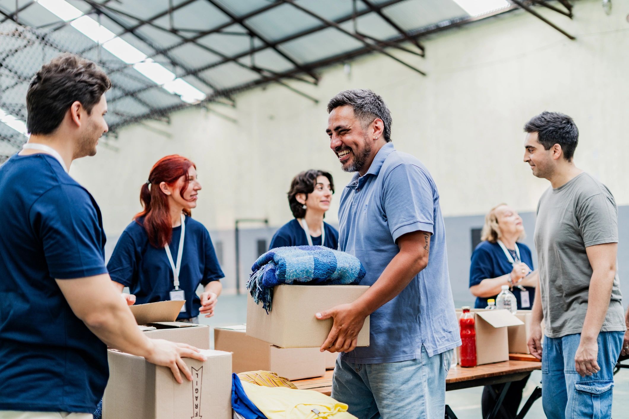 Volunteer receiving a donation box at a community center